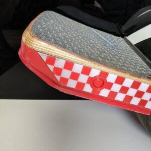 red power button cover installed on matching Onewheel